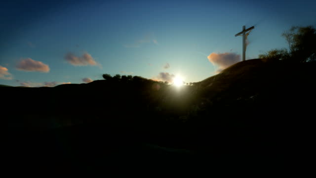 Christian-woman-praying-at-Jesus-cross-at-sunrise,-4K