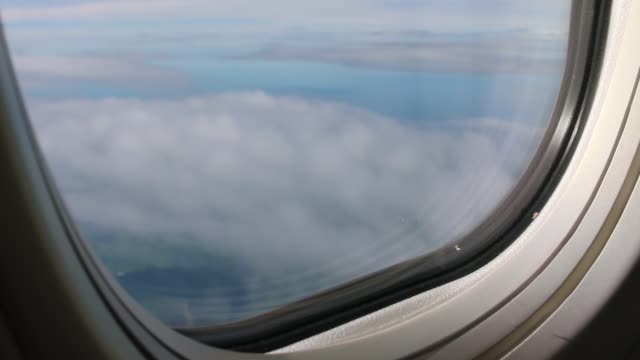 Airplane-engine-in-flight-view-through-an-airplane-window-seeing-clouds-for-travel-around-the-world