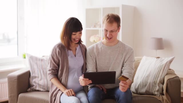 man-and-pregnant-wife-shopping-online-at-home