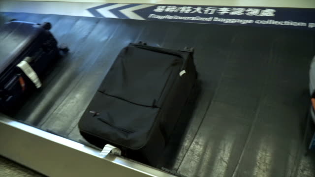 Various-suitcases-on-conveyor-belt-in-the-international-airport