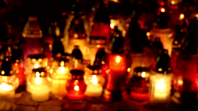 Grave-candles-on-cementery-in-the-night.-All-Saints-Day.-Defocus-shot.