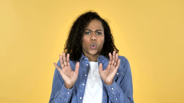 African-Girl-Confused-and-Scared-of-Problems-Isolated-on-Yellow-Background