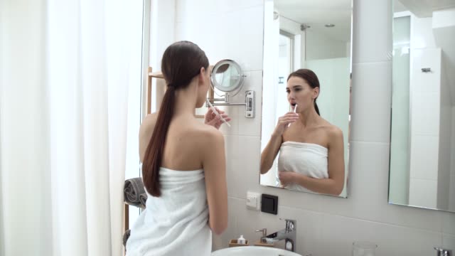 Dental-Health.-Woman-Brushing-Teeth-In-Bathroom