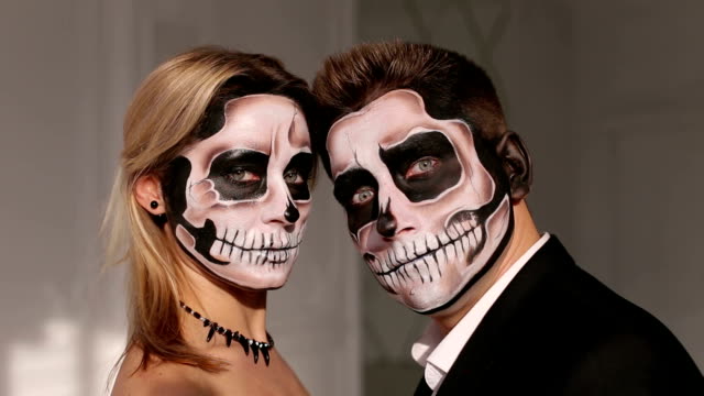 A-man-and-a-woman-in-a-dress-and-costume-with-a-creepy-Halloween-makeup.