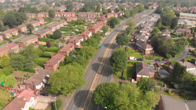 Aerial-footage-of-the-British-UK-town-of-Cookridge-/-Tinshill-just-outside-the-Leeds-City-Centre-area-in-West-Yorkshire-on-a-bright-sunny-day,-showing-a-typical-British-housing-estate.