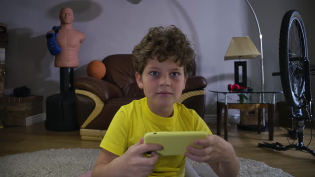 Little-Caucasian-boy-with-red-tired-eyes-looking-at-the-screen-and-using-smartphone.-Caucasian-teenage-kid-having-games-addiction.-Technologies,-internet,-video-games.-Cinema-4k-ProRes-HQ.