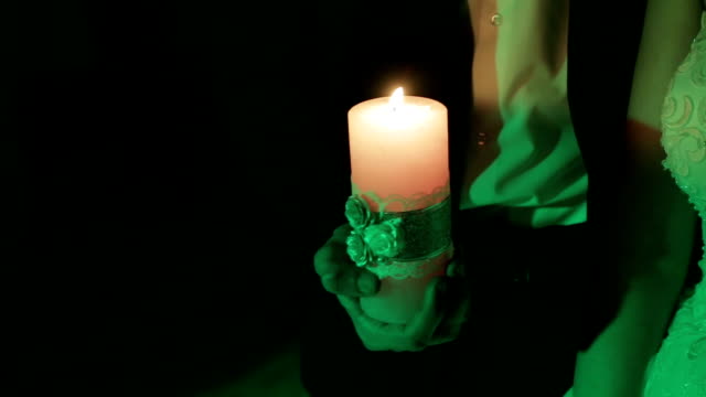 Burning-candle-in-the-hand-of-men-in-the-dark.-Slow-motion-shot