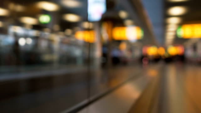 People-hurrying-to-plane,-walking-on-elevator,-passing-by-terminals-in-airport