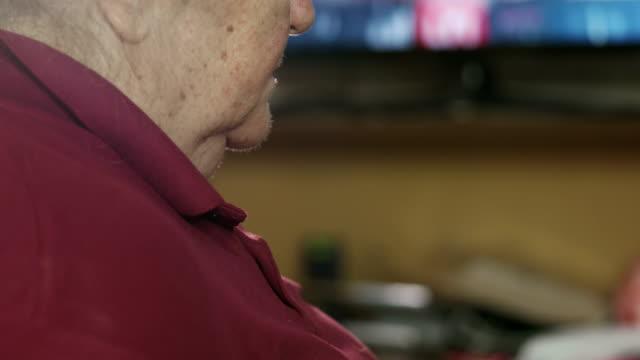Elderly-woman-sleeping-in-front-of-TV.