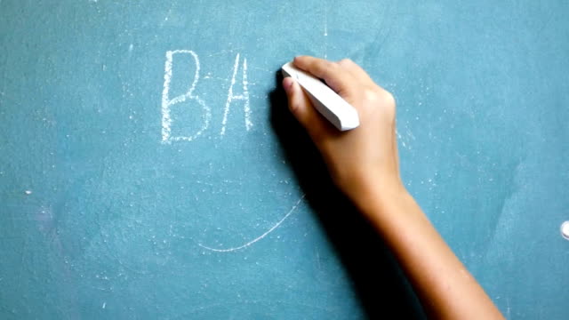 Child's-hand-writes-on-the-chalkboard-words-"Back-to-School!"