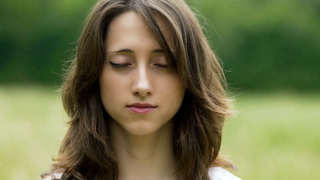 Beautiful-woman-opens-her-eyes-portrait,-female-after-meditation-looks-in-camera
