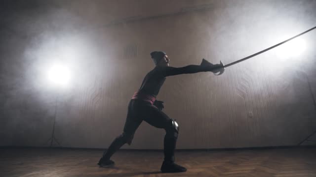 Mittelalterlicher-Krieger-training-mit-Schwert-im-Innenbereich-in-Zeitlupe