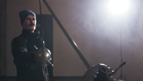 Medieval-warriors-training-with-swords-indoors-in-slow-motion