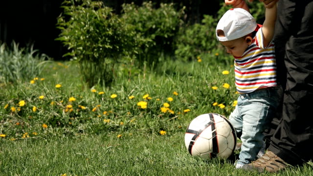 Father-teaches-his-son-to-play-soccer.
