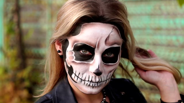 A-bride-with-a-creepy-skull-makeup-for-Halloween-in-an-abandoned-city.