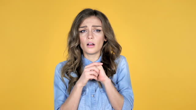 Young-Girl-Confused-and-Scared-of-Problems-Isolated-on-Yellow-Background
