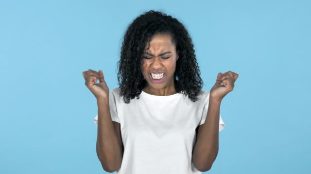 Screaming-Angry-African-Girl-Isolated-on-Blue-Background