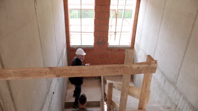 Ingeniero-mostrando-nuevo-apartamento-a-esposa-y-marido-joven