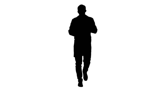 Silhouette-Cheerful-doctor-walking,-talking-and-looking-into-the-camera