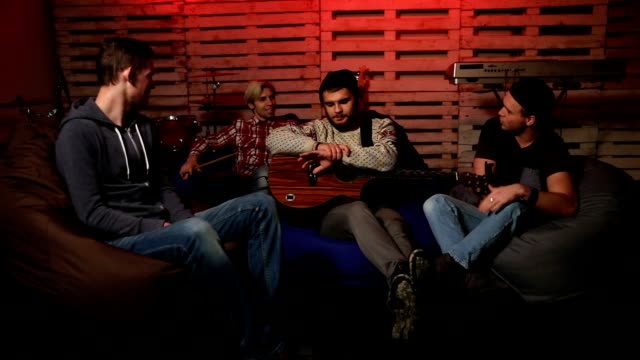 Music-band-relaxing-after-rehearsal-in-club