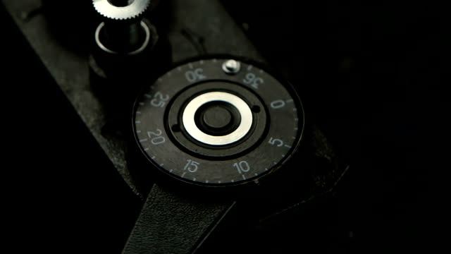 Old-camera-closeup-in-slow-motion.-Pressing-film-rewind-button