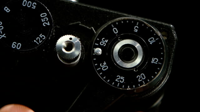 Pressing-film-rewind-button.-Old-camera-closeup-in-slow-motion