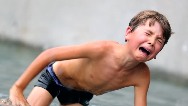 Child-in-real-painful-agony-after-having-been-physically-hurt-at-the-pool.-Young-boy-cries-uncontrollably.-Child-crying-in-real-pain.