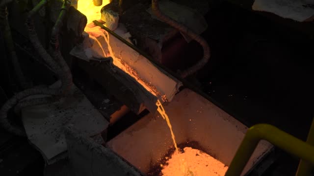 Hot-steel-pouring-at-steel-plant.-In-the-frame,-molten-metal-is-poured-through-special-channels,-for-the-further-rolling-with-a-special-machine.-Modern-metallurgical-industry