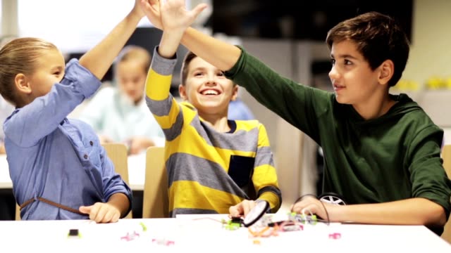happy-children-at-robotics-school-making-high-five