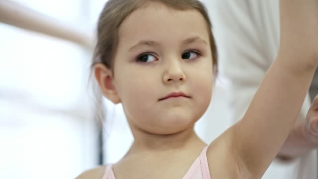 Diligent-Girl-Exercising-with-Ballet-Teacher