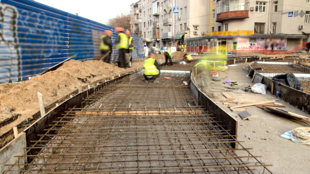 Workers-with-protective-mask-welding-reinforcement-for-tram-tracks-in-the-city-timelapse