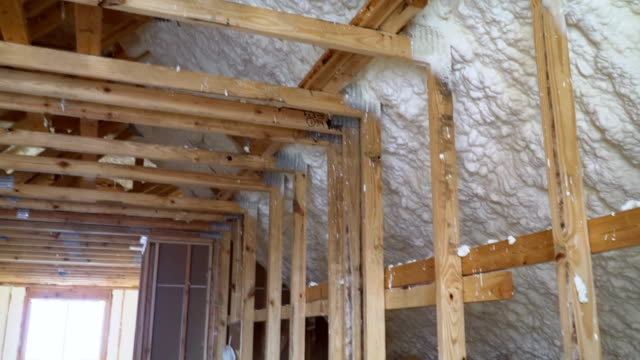 New-home-construction-with-installation-of-attic-with-foam-insulation-the-roof
