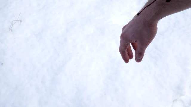 Blood-drips-from-the-hands-into-the-snow.
