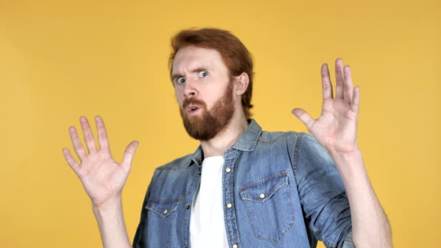 Redhead-Man-Confused-and-Scared-of-Problems-Isolated-on-Yellow-Background