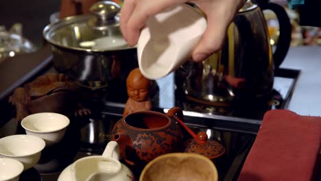 Tea-ceremony.-Master-pours-tea-leaves-in-a-teapot