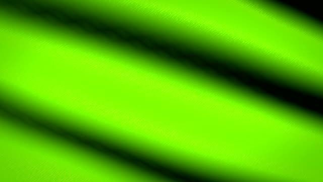 Grüne-Flagge-winken-Textile-strukturierten-Hintergrund.-Seamless-Loop-Animation.-Vollbild.-Slow-Motion.-4K-Video