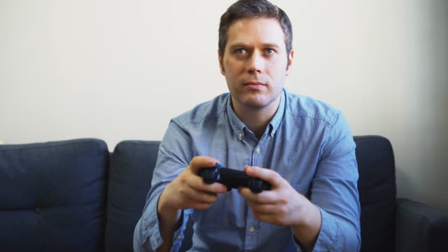 Man-playing-soccer-video-game-on-TV.-Gamepad-controller-in-hands.