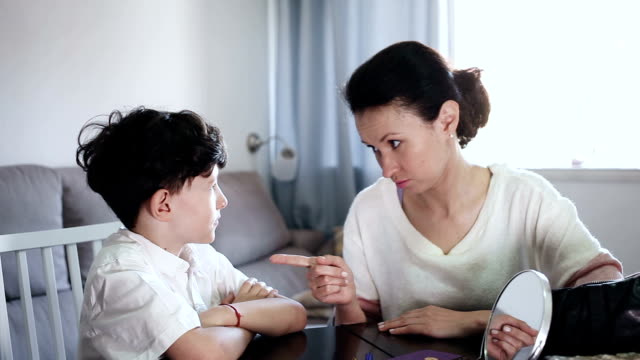 Portrait-of-serious-woman-talking-with-teenage-son