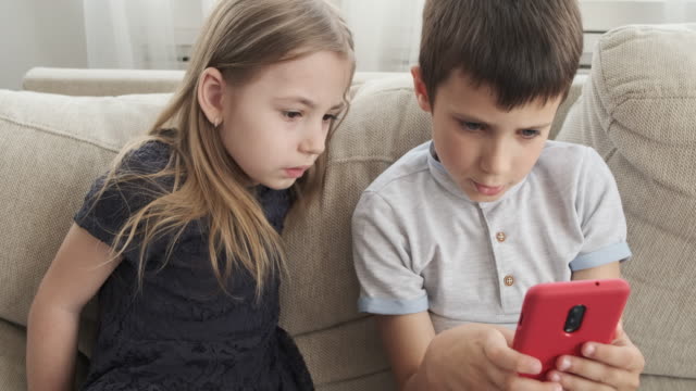 Little-children-playing-game-on-mobile-phone