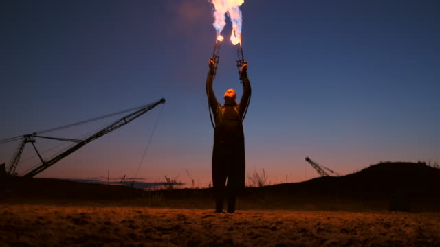 A-man-with-a-flamethrower-at-sunset-in-slow-motion.-Costume-for-zombie-Apocalypse-and-Halloween.