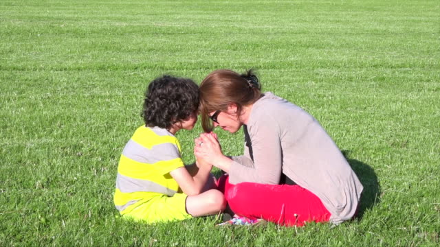 Mother-and-son-praying-outdoors