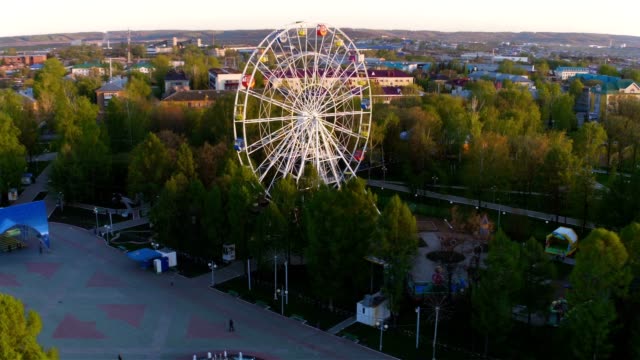 Park-with-Tracks-and-Large-White-Ferris-Wheel-Aerial-View