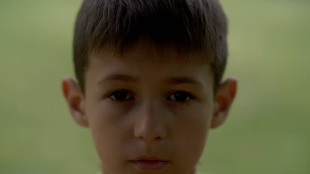 portrait-of-little-sad-desperate-kid-looking-at-camera,-close-up