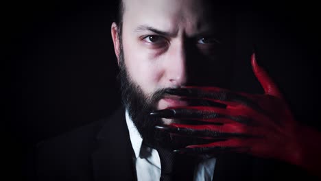 4k-Horror-Devil's-Hand-Covering-Businessman-Mouth