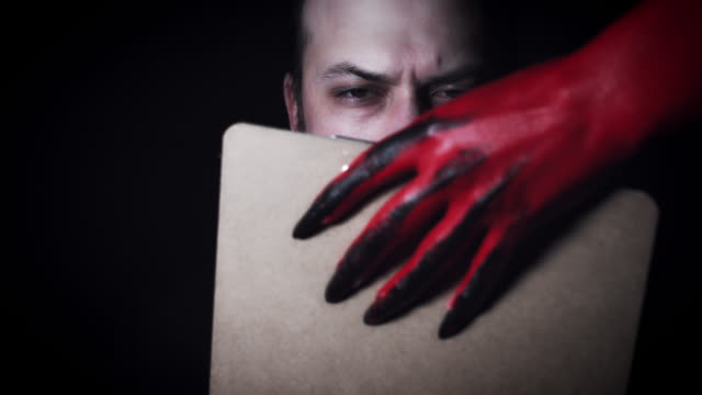4k-Horror-Devil's-Hand-Giving-Businessman-Contract-to-Sign