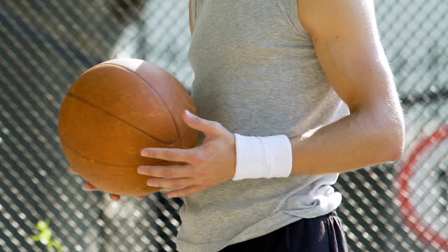 White-handsome-man-spinning-basket-ball-on-finger,-summer-activities,-balance