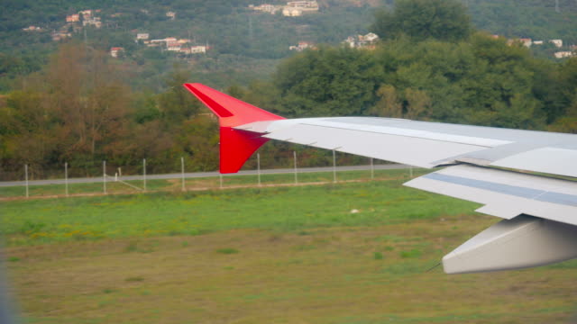 wing-of-the-aircraft-standing-on-the-ground-on-the-runway