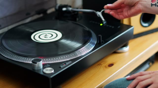 woman-turns-off-the-turntable-takes-the-LP
