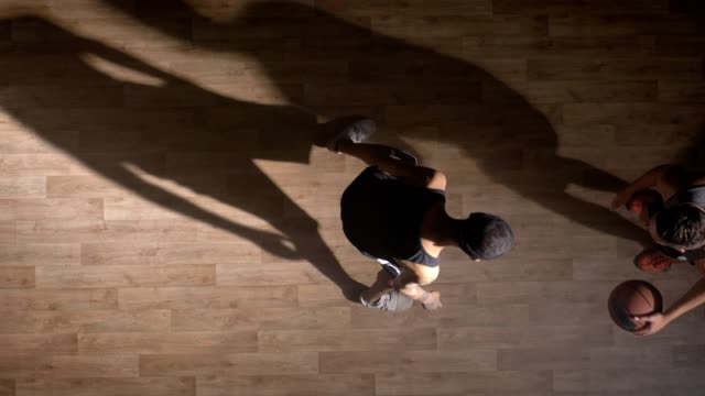 Topview,-two-basketball-players-playing-one-on-one-indoors