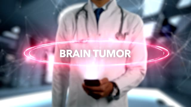 Brain-tumor---Male-Doctor-With-Mobile-Phone-Opens-and-Touches-Hologram-Illness-Word